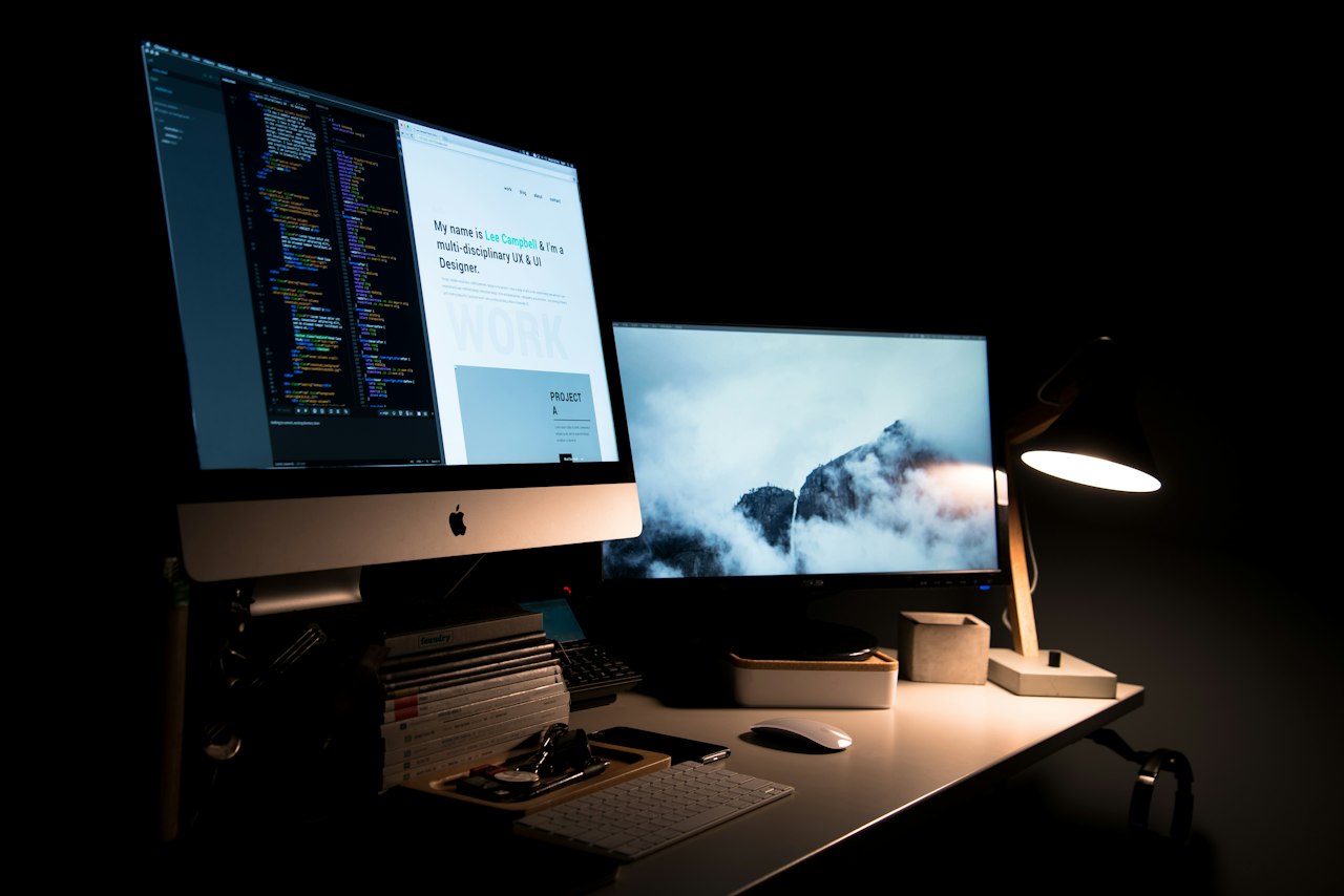 Designer workspace with monitor and sketches during a website redesign